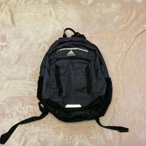 Black and grey adidas backpack with white zipper. 4 zippers (2 big 2 small)